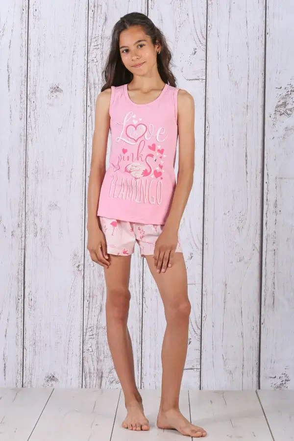 a girl in pink tank top and shorts posing for a picture