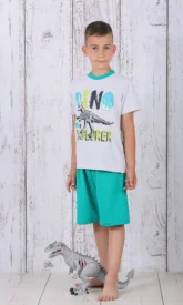 a boy standing next to a toy dinosaur