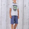 a boy standing in front of a white wood wall