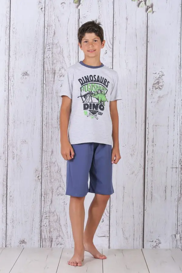 a boy standing in front of a white wood wall