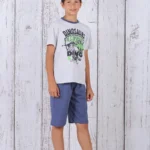 a boy standing in front of a white wood wall