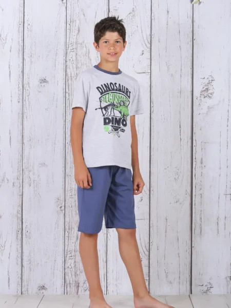 a boy standing in front of a white wood wall